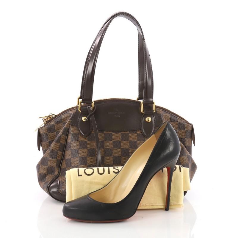 This Louis Vuitton Verona Handbag Damier PM, crafted in brown damier coated canvas, features dual flat handles, slightly winged sides, and gold-tone hardware accents. Its zip closure opens to a red fabric interior with slip pocket. Authenticity code