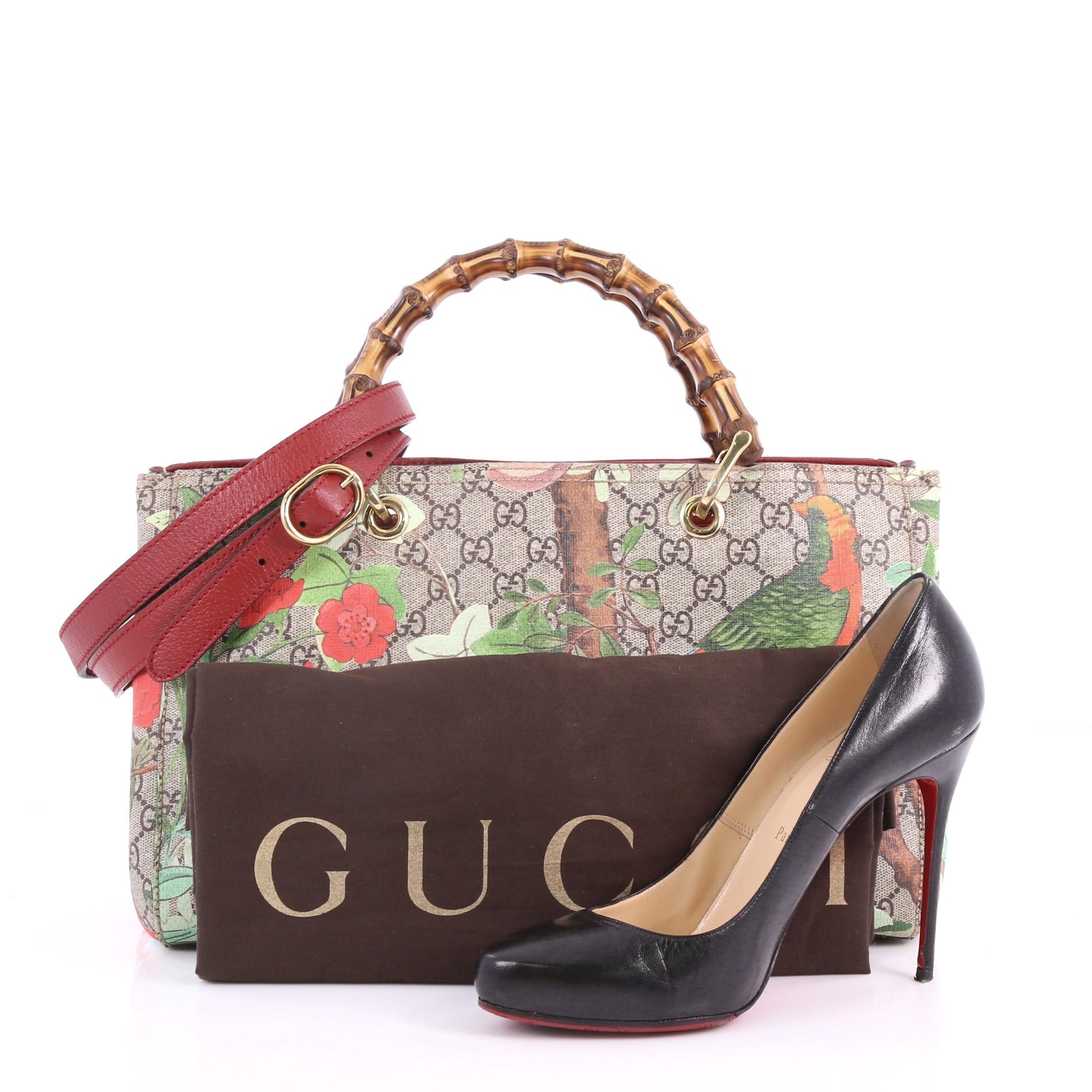 This Gucci Bamboo Shopper Tote Tian Print GG Coated Canvas Medium, crafted from multicolored Tian print GG coated canvas, features sturdy bamboo handles, protective base studs and gold-tone hardware. Its hidden magnetic snap closure opens to a brown