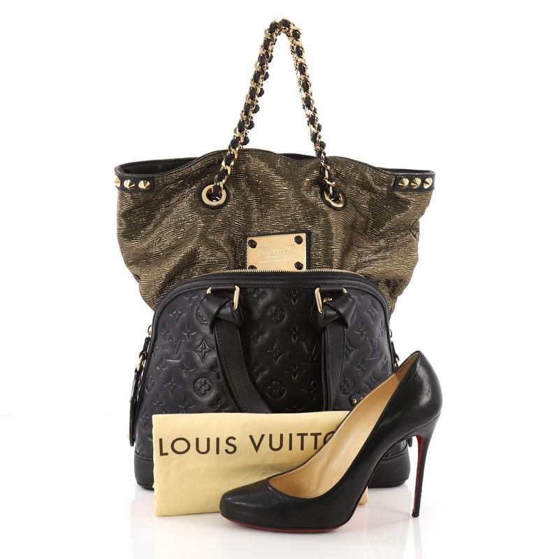 This Louis Vuitton Double Jeu Neo Alma Handbag Limited Edition Monogram, crafted from black monogram leather, features dual flat leather handles, studded LV detailing and gold-tone hardware accents. Its two-way zip closure opens to a black