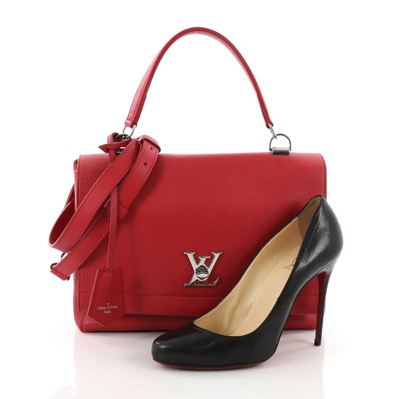 This Louis Vuitton Lockme II Handbag Leather, crafted from red leather, features a single loop leather handle, over-scale LV turn-lock closure and silver-tone hardware. Its turn-lock closure opens to a red fabric-lined interior with slip pockets.
