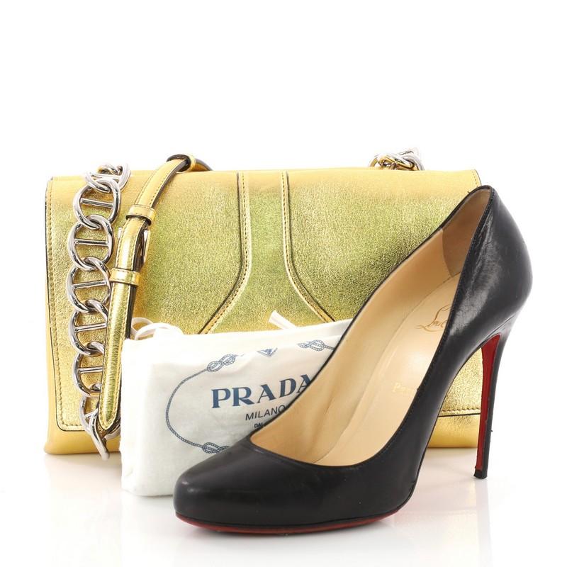 This Prada Turnlock Flap Chain Bag Leather Small, crafted in gold leather, features a chain-link with leather handle and silver-tone hardware. Its turn-lock closure opens to a black leather interior. **Note: Shoe photographed is used as a sizing