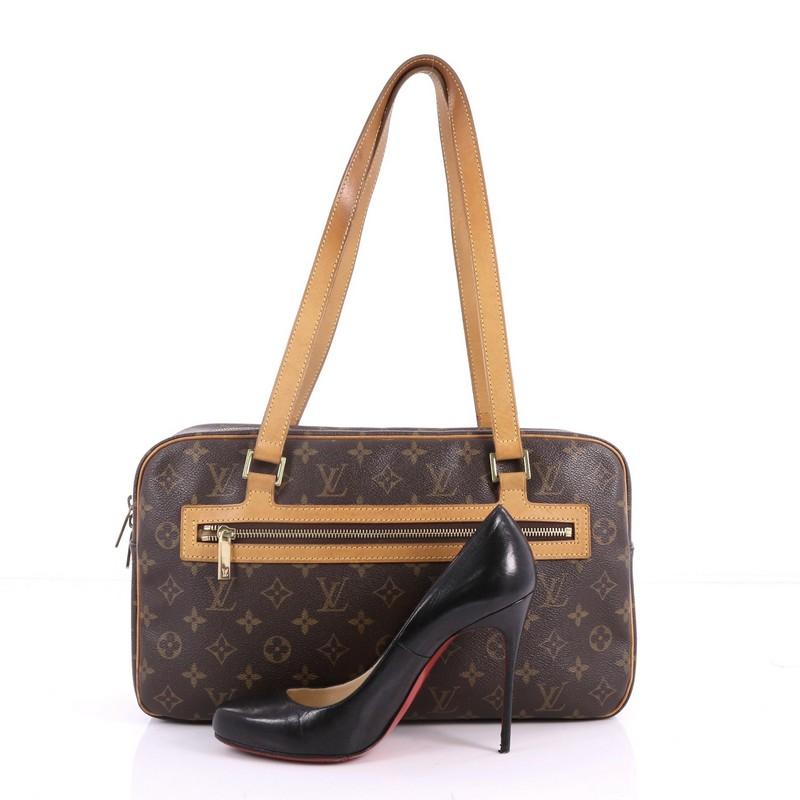 This authentic Louis Vuitton Cite Handbag Monogram Canvas GM is perfect for everyday use. Crafted in brown monogram coated canvas with vachetta leather trims, this bag features long-dual flat vachetta leather handles, front zip pocket and gold-tone