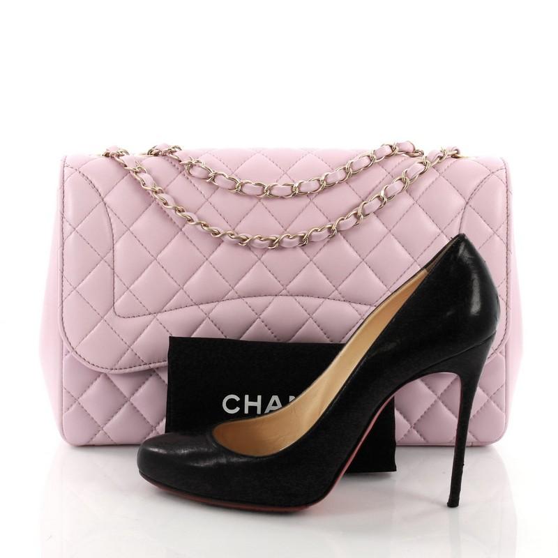 This Chanel Mademoiselle Chic Flap Bag Quilted Lambskin Jumbo, crafted from pink quilted lambskin, features woven-in leather chain strap, exterior back slip pocket and matte gold-tone hardware. Its turn-lock closure opens to a pink fabric interior