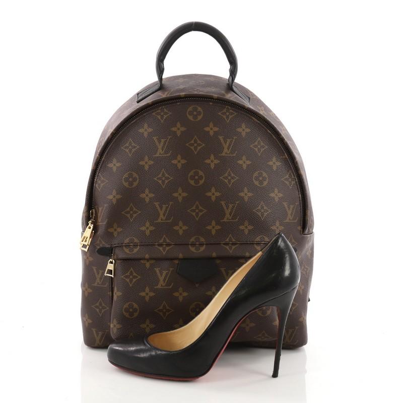 This Louis Vuitton Palm Springs Backpack Monogram Canvas MM, crafted from brown monogram coated canvas, features adjustable padded backpack shoulder straps, exterior front zip pocket, and gold-tone hardware. Its two-way zip closure opens to a black