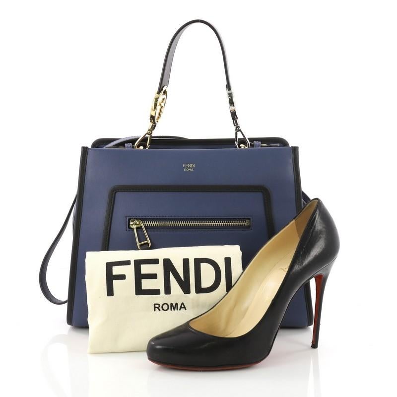 This Fendi Runaway Handbag Leather Small, crafted from blue leather, features a flat leather handle, exterior zip pocket and silver and gold-tone hardware. Its magnetic snap button closure opens to a gray microfiber interior with zip and slip