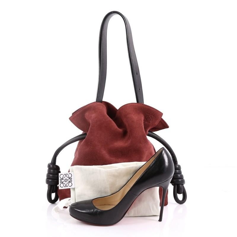 This Loewe Flamenco Knot Bag Suede Medium, crafted from dark red suede, features a soft construction with T-bar profile, adjustable leather shoulder strap, knotted drawstring and gold-tone hardware. Its drawstring closure opens to a beige fabric