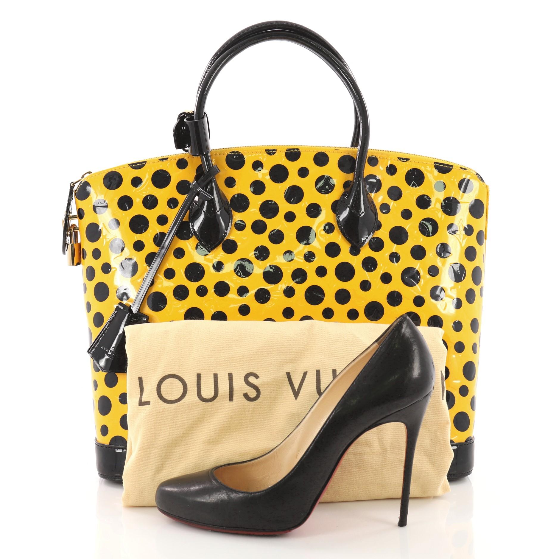 This Louis Vuitton Lockit Handbag Monogram Vernis Kusama Infinity Dots MM, crafted from yellow printed monogram vernis leather,  features dual rolled leather handles, black patent leather trims, and gold-tone hardware accents. Its zip closure opens
