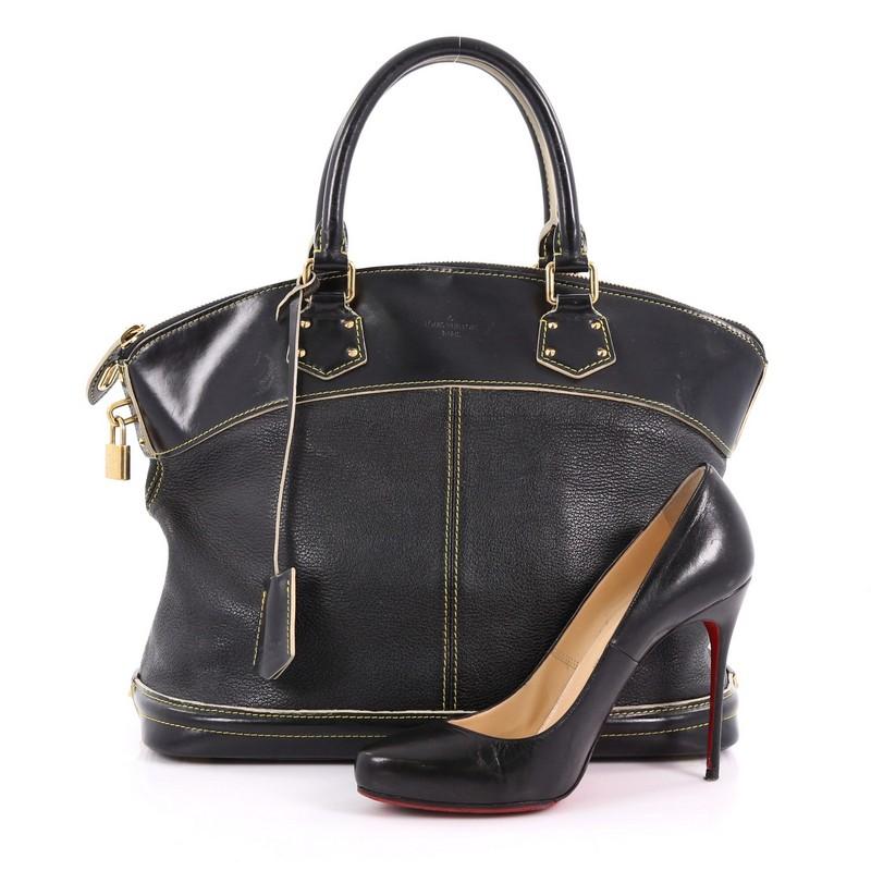 This Louis Vuitton Suhali Lockit Handbag Leather MM, crafted from black leather, feature dual rolled handles, standout contrast stitching, and gold-tone hardware. The top zip closure opens to a black fabric interior with side zip pocket.