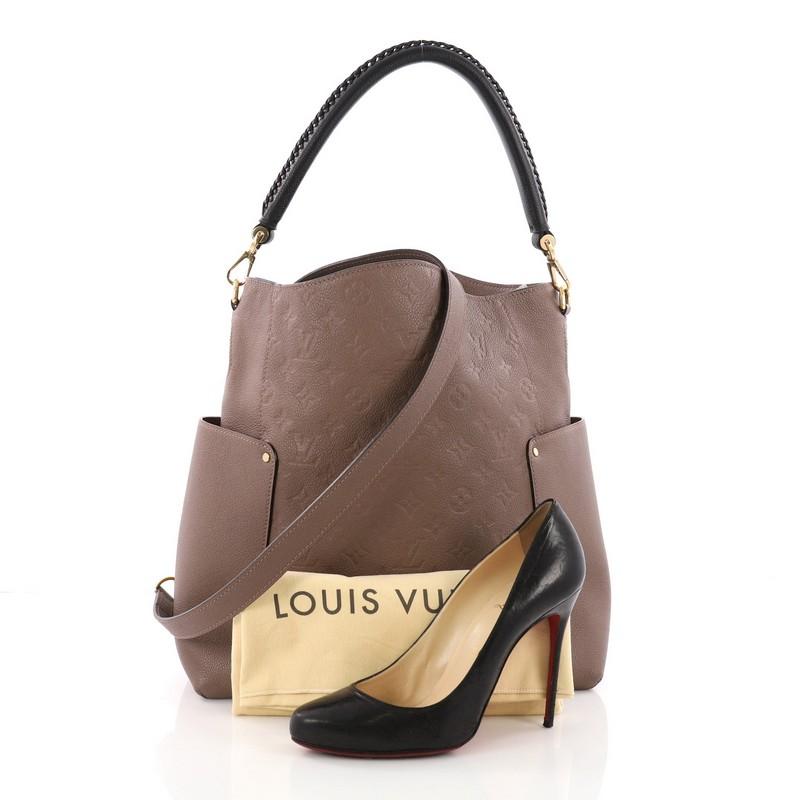 This Louis Vuitton Bagatelle Hobo Monogram Empreinte Leather, crafted from taupe monogram empreinte leather, features a braided handle, exterior flat pockets on each side and gold-tone hardware. Its wide open top showcases a taupe fabric interior