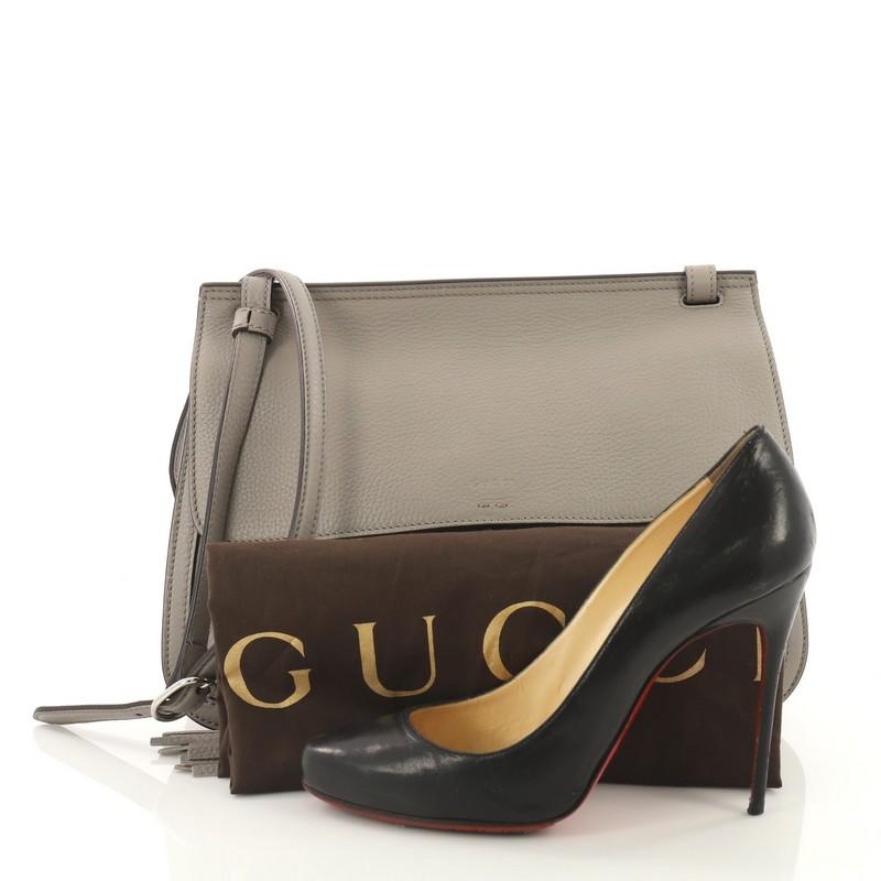 This authentic Gucci Bamboo Daily Flap Bag Leather is a simple yet elegant crossbody bag for the on-the-go woman. Crafted in gray leather, this bag features frontal flap with bamboo tassel fringes, adjustable leather strap, subtle Gucci logo imprint