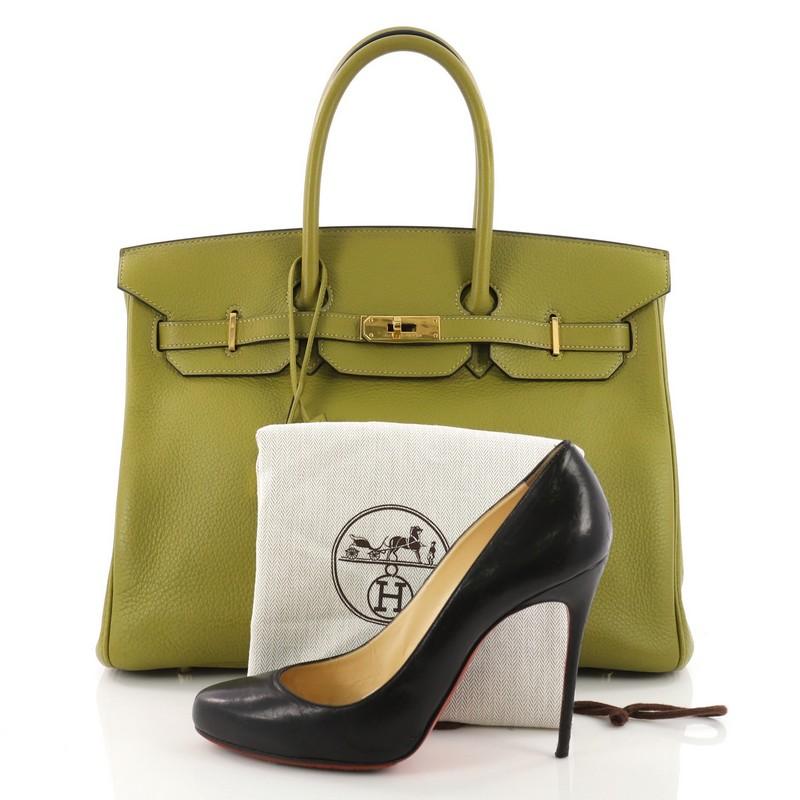 This Hermes Birkin Handbag Vert Chartreuse Clemence with Gold Hardware 35, crafted from Vert Chartreuse clemence leather, features dual rolled handles, front flap and gold-tone hardware. Its turn-lock closure opens to a green leather interior with
