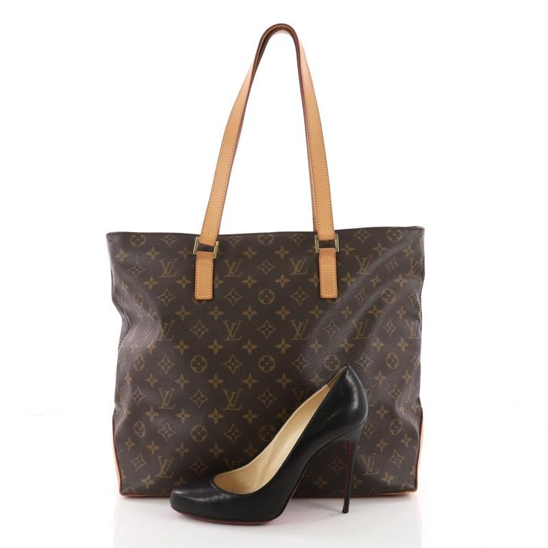 This Louis Vuitton Cabas Mezzo Monogram Canvas, crafted from brown monogram coated canvas, features dual flat leather handles, vachetta leather trims and gold-tone hardware. Its top zip closure opens to a brown fabric interior with a cell phone