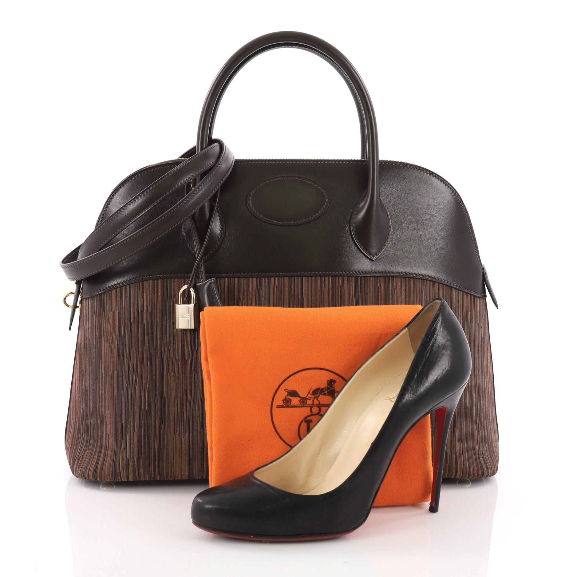 This Hermes Bolide Handbag Vibrato and Box Calf 35, crafted from brown leather and Vibrato, features dual rolled leather handles, and gold-tone hardware. Its zip closure opens to a brown leather interior with slip pocket. Date stamp reads: H Square