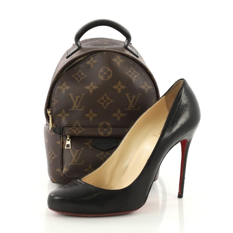This Louis Vuitton Palm Springs Backpack Monogram Canvas Mini, crafted from brown monogram coated canvas, features an adjustable shoulder strap, exterior front zip pocket, and gold-tone hardware. Its two-way zip closure opens to a black fabric