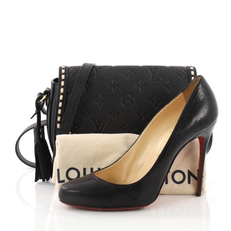 This Louis Vuitton Junot Handbag Monogram Empreinte Leather, crafted from black monogram empreinte leather, features adjustable shoulder strap, stitched detailing, and gold-tone hardware. Its push-lock closure opens to a black microfiber interior