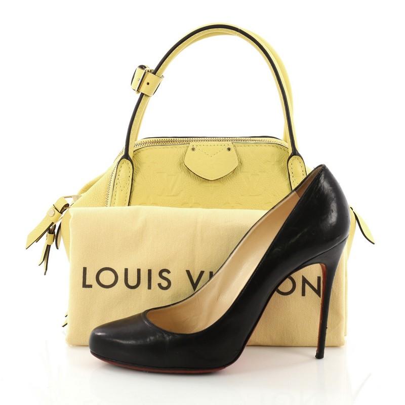 This Louis Vuitton Marais Handbag Monogram Empreinte Leather BB, crafted from yellow monogram empreinte leather, features reversed toron handles, protective base studs and gold-tone hardware. Its zip closures opens to a striped yellow fabric
