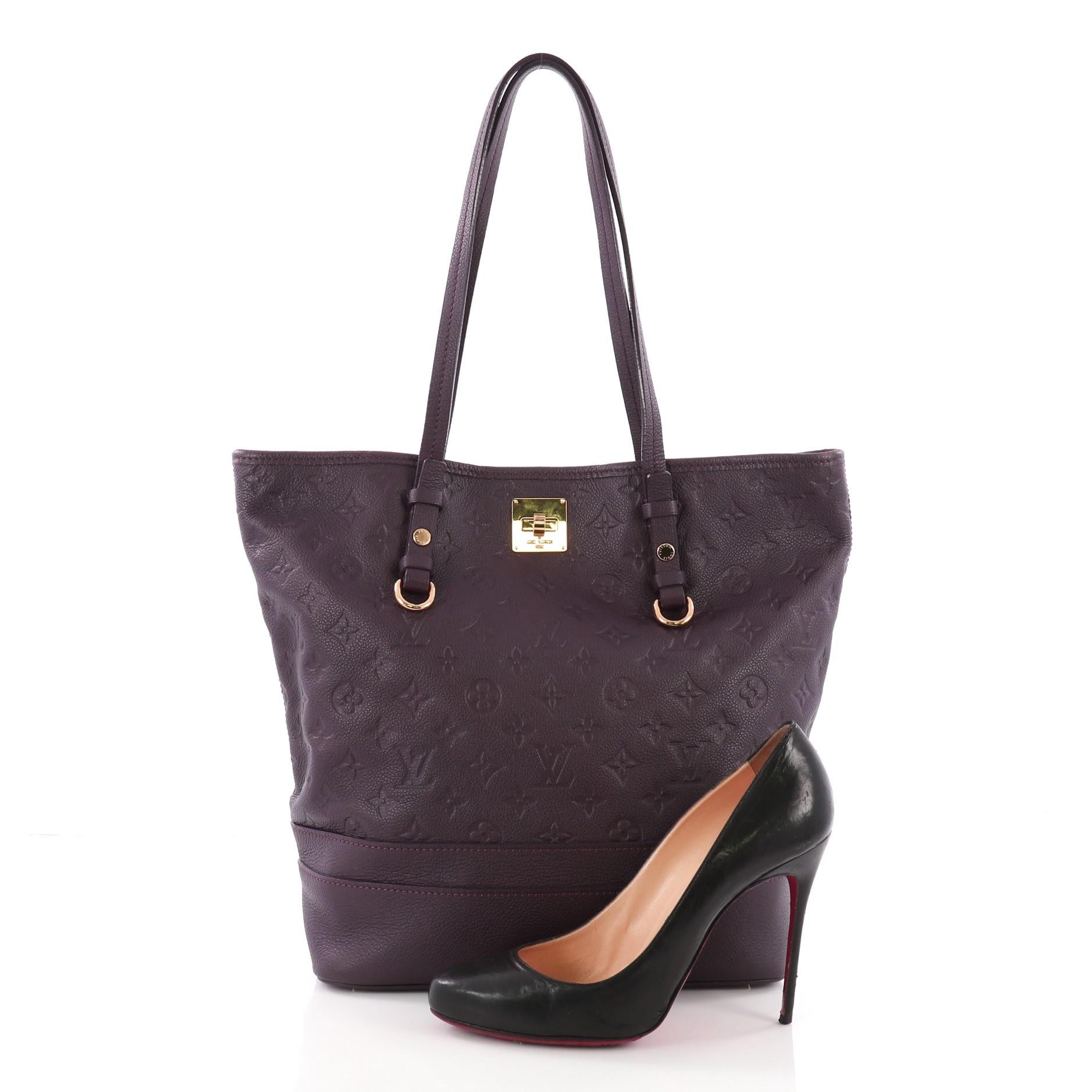 This Louis Vuitton Citadine Handbag Monogram Empreinte Leather PM, crafted in purple embossed monogram empreinte leather, features slim handles, protective base studs and gold-tone hardware. Its turn-lock closure opens to a purple fabric interior.