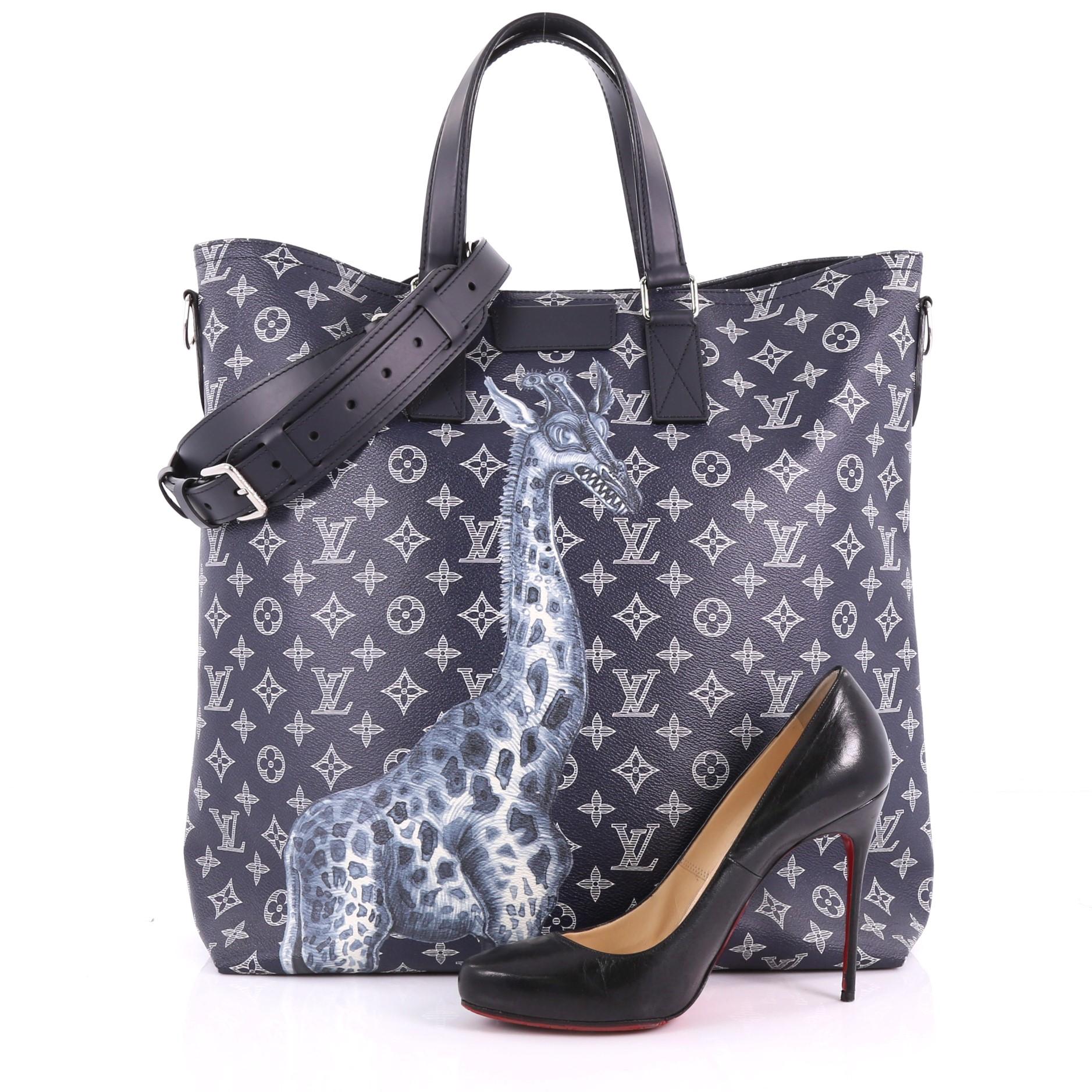 This Louis Vuitton Tote Limited Edition Monogram Savane Canvas, crafted in blue monogram coated canvas with signature giraffe print at front, features dual-flat leather handles, and silver-tone hardware. Its magnetic snap button closure opens to a