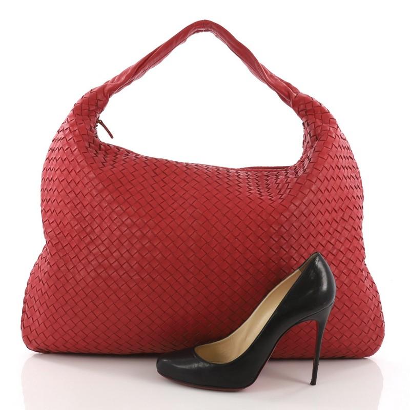This Bottega Veneta Veneta Hobo Intrecciato Nappa Maxi, crafted in red nappa leather woven in signature intrecciato method, features a single shoulder strap, and gold-tone hardware. Its top zip closure opens to a taupe suede interior and showcases a