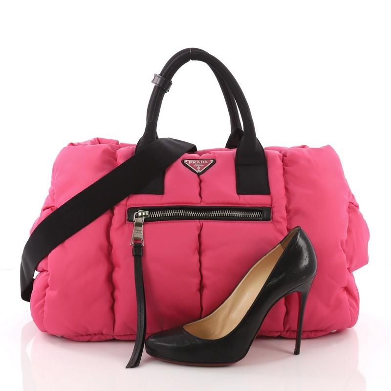 This Prada Bomber Convertible Tote Tessuto Large, crafted in pink tessuto nylon, features dual-rolled handles, exterior zip pockets, and silver-tone hardware. Its top zip closure opens to a black nylon interior with zip and slip pockets. **Note:
