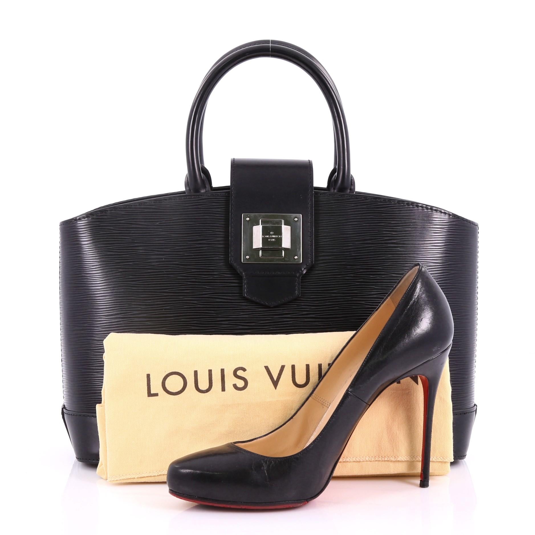 This Louis Vuitton Mirabeau Handbag Epi Leather PM, crafted from black epi leather, features dual rolled top handles, protective base studs and silver-tone hardware. Its turn-lock closure opens to a black microfiber interior with side zip and slip