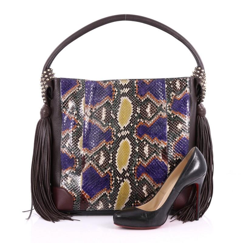 This Christian Louboutin Eloise Fringe Hobo Python with Leather Medium, crafted in genuine multicolor python skin and brown leather, features flat leather shoulder strap, swinging fringe and spiked sides, and gold-tone hardware. Its zip closure