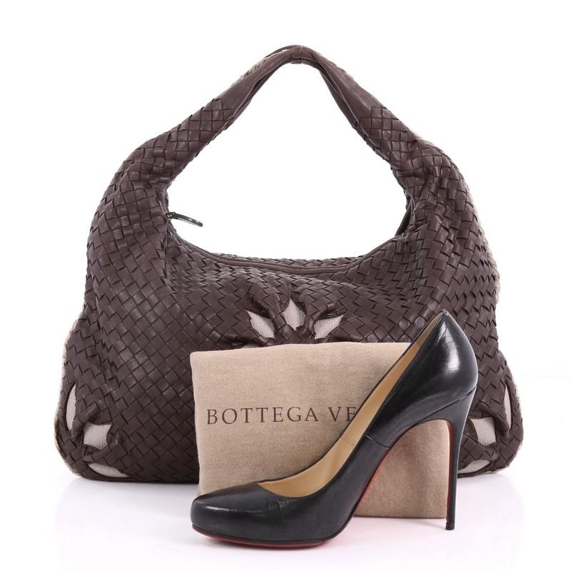 This Bottega Veneta Veneta Hobo Cut Out Intrecciato Nappa Large, crafted from brown nappa leather woven in Bottega Veneta's signature intrecciato method, features a single looped strap, decorative frontal floral cut-out pattern and brass-tone