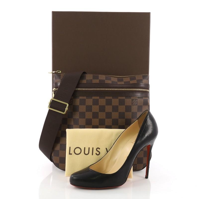 This Louis Vuitton Bosphore Pochette Damier, crafted in damier ebene coated canvas, features an adjustable textile shoulder strap, exterior front zipper pocket, and gold-tone hardware. Its top zip closure opens to a brown fabric interior perfect for