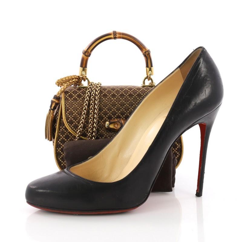 This Gucci New Bamboo Top Handle Bag Diamante Jacquard Mini, crafted in brown and gold Diamante Jacquard, features a bamboo top handle, and bamboo and gold-tone hardware. Its bamboo turn-lock closure opens to a gold leather interior with side slip