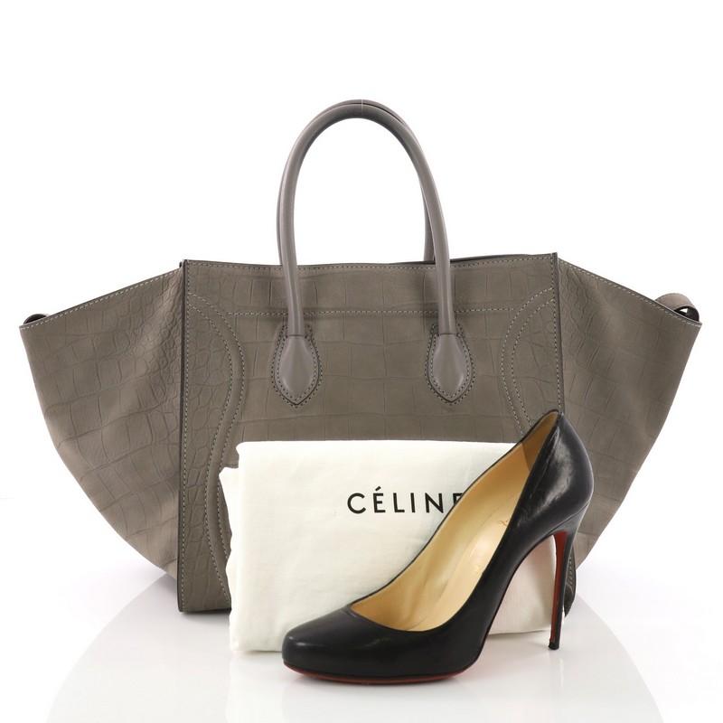 This Celine Phantom Handbag Crocodile Embossed Nubuck Medium, crafted in genuine gray crocodile embossed nubuck, features dual rolled handles, exterior zip pocket, and gold-tone hardware. It opens to a gray leather interior with zip pocket. **Note: