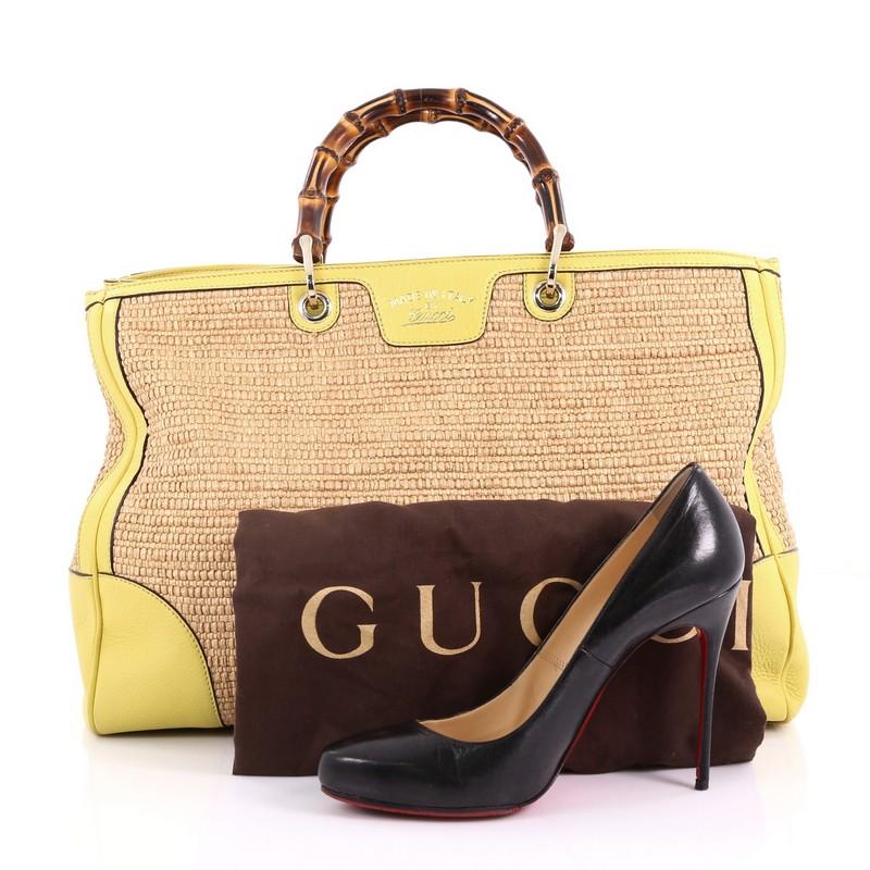This Gucci Bamboo Shopper Tote Straw Large, crafted in brown straw and yellow leather, features Gucci's signature sturdy bamboo handles, stamped logo at the front and gold-tone hardware. Its hidden magnetic snap closure opens to a multicolor canvas