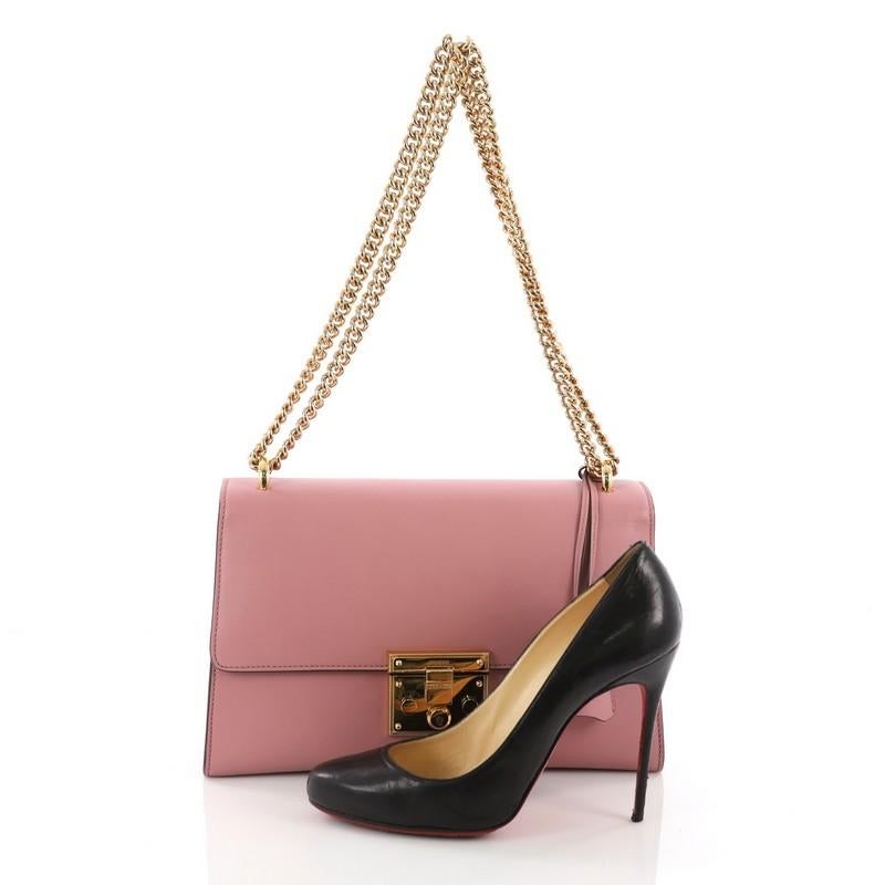 This Gucci Padlock Shoulder Bag Leather Medium, crafted in pink leather, features chunky chain link strap, exterior back card pocket, and gold-tone hardware. Its signature padlock push-lock closure opens to a brown microfiber interior with slip and