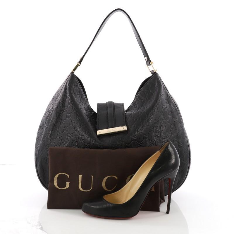 This Gucci New Ladies Web Tote Guccissima Leather Medium, crafted in black guccisima leather, features a flat leather handle, engraved Gucci script logo on flap tab and gold-tone hardware. Its magnetic snap closure opens to a black fabric interior