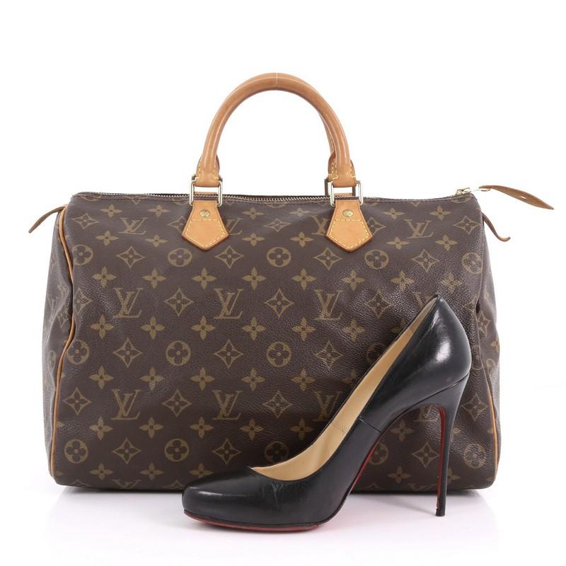 This Louis Vuitton Speedy Handbag Monogram Canvas 35, crafted in brown monogram coated canvas, features dual rolled vachetta leather handles, vachetta leather piping and gold-tone hardware. Its top zip closure opens to a brown fabric interior with