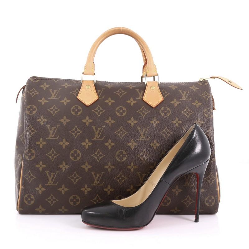 This Louis Vuitton Speedy Handbag Monogram Canvas 35 , crafted in brown monogram coated canvas, features dual rolled vachetta leather handles, vachetta leather piping and gold-tone hardware. Its top zip closure opens to a brown fabric interior with