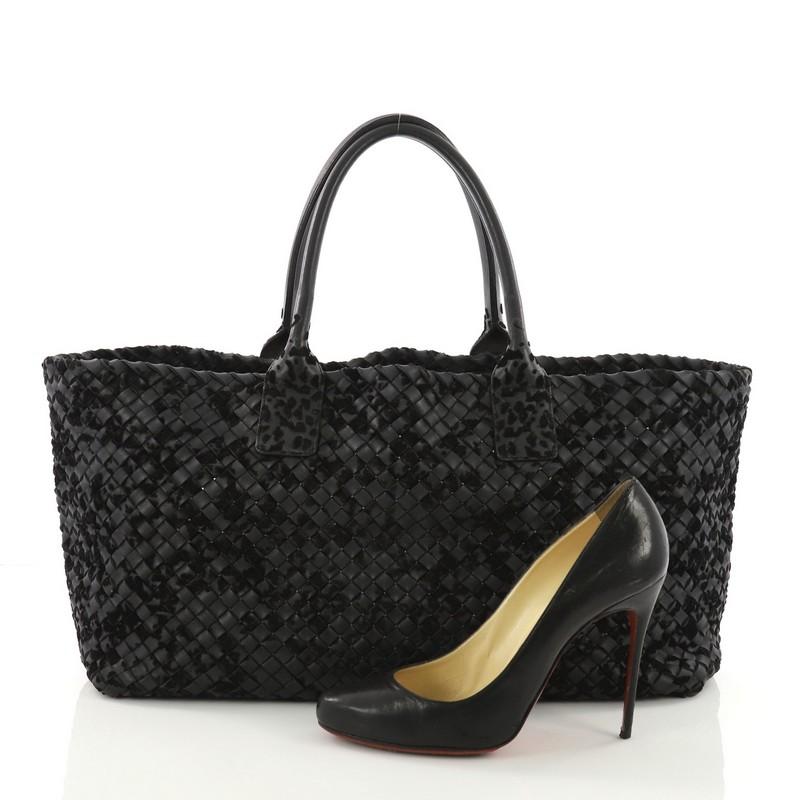 This Bottega Veneta Cabat Tote Velours and Intrecciato Nappa Medium, crafted in black intrecciato woven nappa leather, features tall dual-rolled leather handles with a black leather interior base. **Note: Shoe photographed is used as a sizing