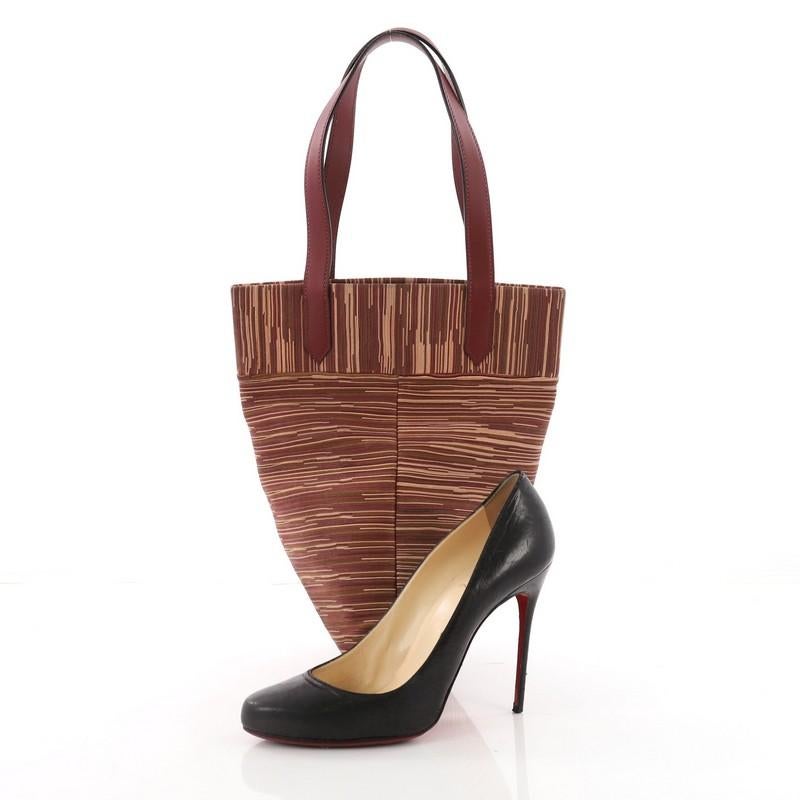 This Hermes Jules Tote Vibrato Mini, crafted from Multicolor Rouge H Box Calf & Vibrato leather, features dual flat leather handles. It opens to a burgundy leather interior. Date stamp reads: F Square (2002) **Note: Shoe photographed is used as a