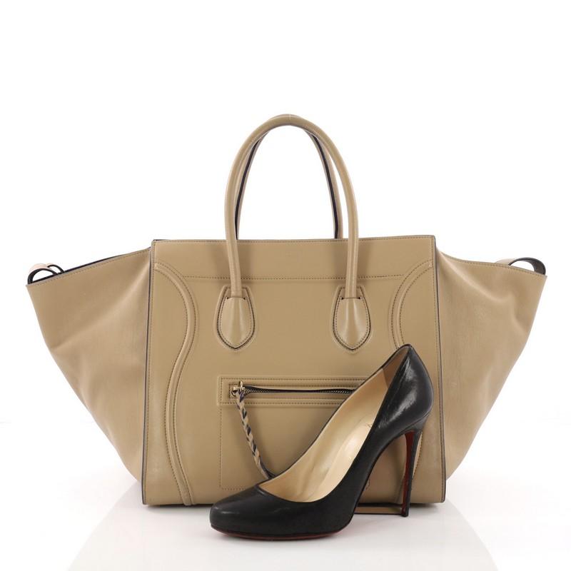 This Celine Phantom Handbag Smooth Leather Medium, crafted in tan smooth leather, features dual rolled handles, front zip pocket, and gold-tone hardware. It opens to a blue suede interior with side zip pocket. **Note: Shoe photographed is used as a