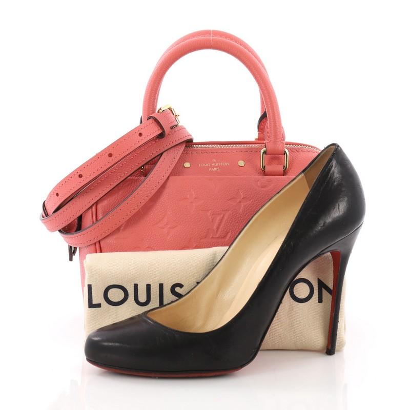 This Louis Vuitton Speedy Bandouliere NM Handbag Monogram Empreinte Leather 20, crafted in pink monogram empreinte leather, features dual-rolled leather handles, and gold-tone hardware. Its two-way zip closure opens to a striped pink fabric interior