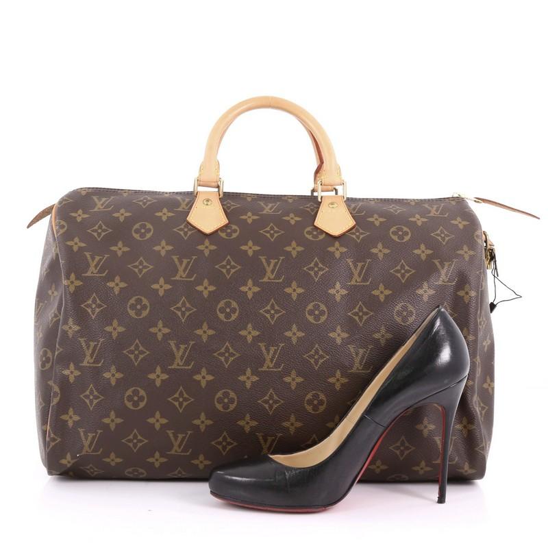 This Louis Vuitton Speedy Handbag Monogram Canvas 40, crafted in brown monogram coated canvas, features dual-rolled leather handles, vachetta leather trims, and gold-tone hardware. Its top zip closure opens to a brown fabric interior with slip