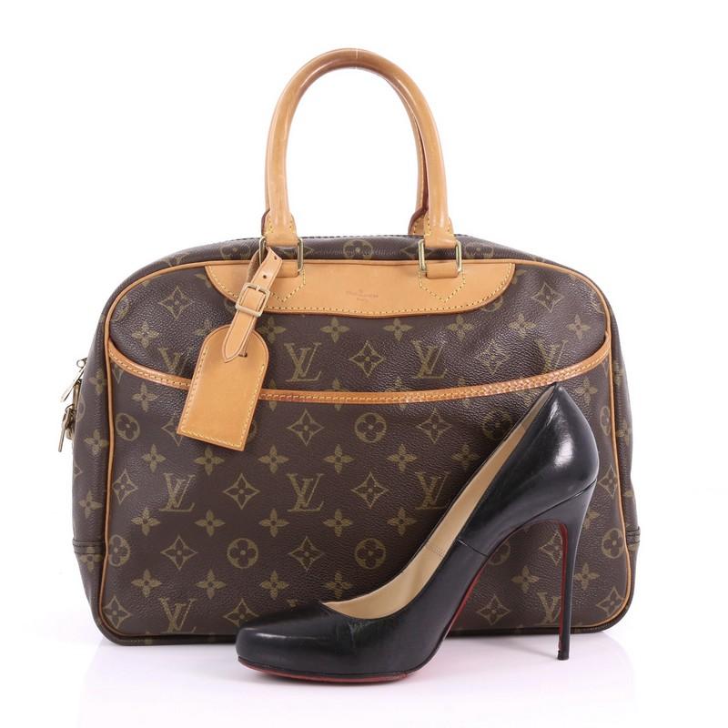 This Louis Vuitton Deauville Handbag Monogram Canvas crafted from brown monogram coated canvas, features dual rolled vachetta leather handles and trims, exterior front slip pocket, and gold-tone hardware. Its top zipped closure opens to a beige