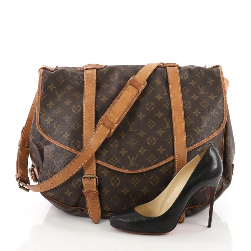 This Louis Vuitton Saumur Handbag Monogram Canvas 43, crafted in brown monogram coated canvas, features long adjustable strap, double saddle compartments with side buckle vachetta leather closures at its frontal flaps and gold-tone hardware. Its
