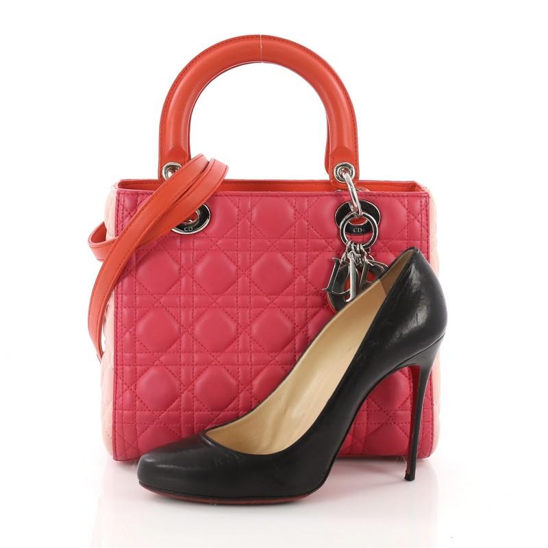 This Christian Dior Tricolor Lady Dior Handbag Cannage Quilt Leather Medium, crafted from tricolor pink cannage quilt leather, features smooth short dual handles with sleek Dior charms and silver-tone hardware. Its zip closure opens to a red orange