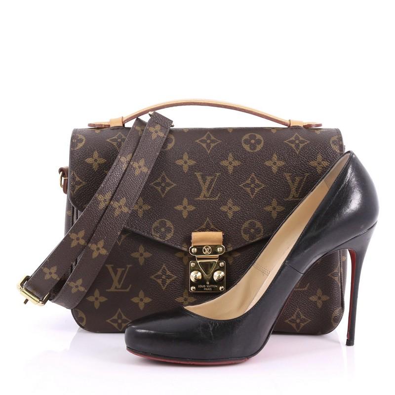This Louis Vuitton Pochette Metis Monogram Canvas, crafted in brown monogram coated canvas, features vachetta leather top handle, exterior back zip pocket, and gold-tone hardware. Its S-lock closure opens to a brown microfiber interior with two open