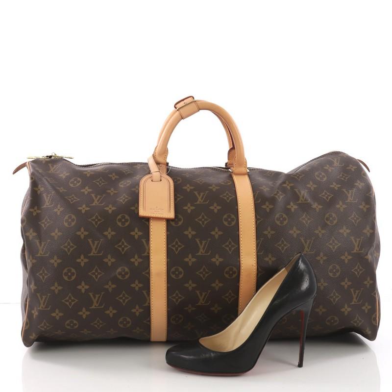 This Louis Vuitton Keepall Bag Monogram Canvas 55, crafted in brown monogram coated canvas, features dual rolled leather handles, vachetta leather trim and gold-tone hardware. Its two-way zip closure opens to a brown fabric interior. Authenticity
