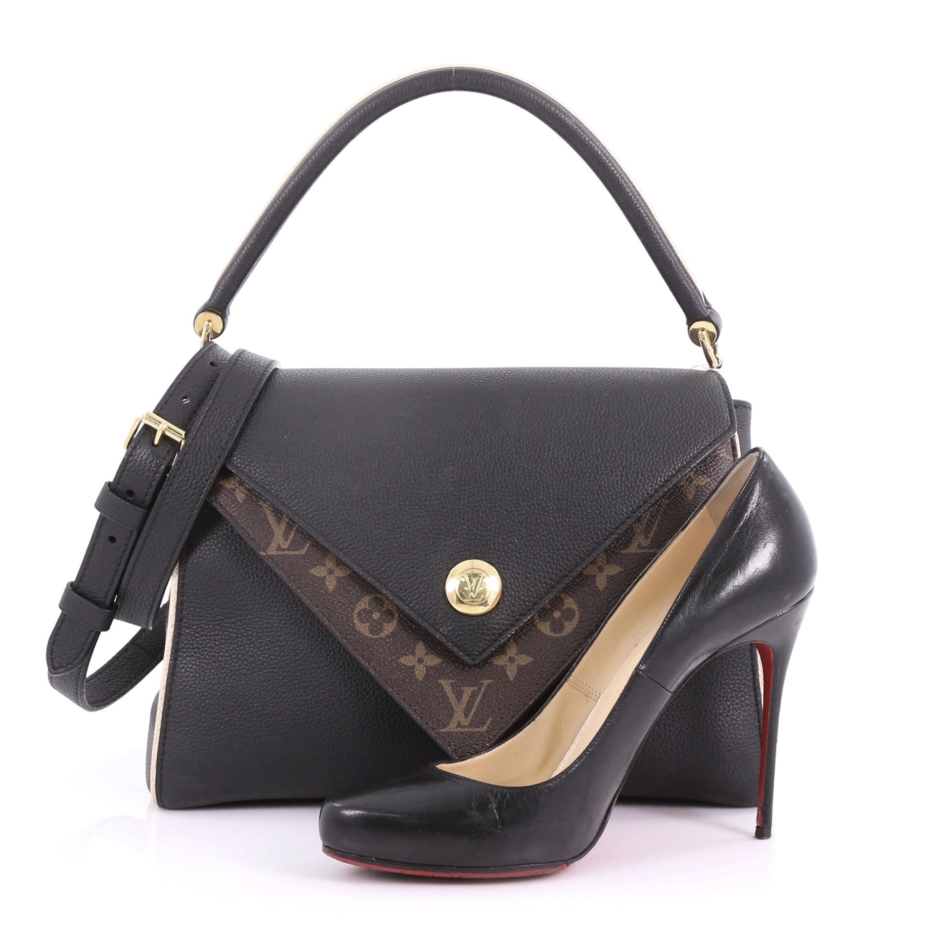 This Louis Vuitton Double V Handbag Calfskin and Monogram Canvas, crafted in black calfskin leather and monogram coated canvas, features a rolled top handle, exterior back pocket and gold-tone hardware. Its magnetic snap button closure opens to a