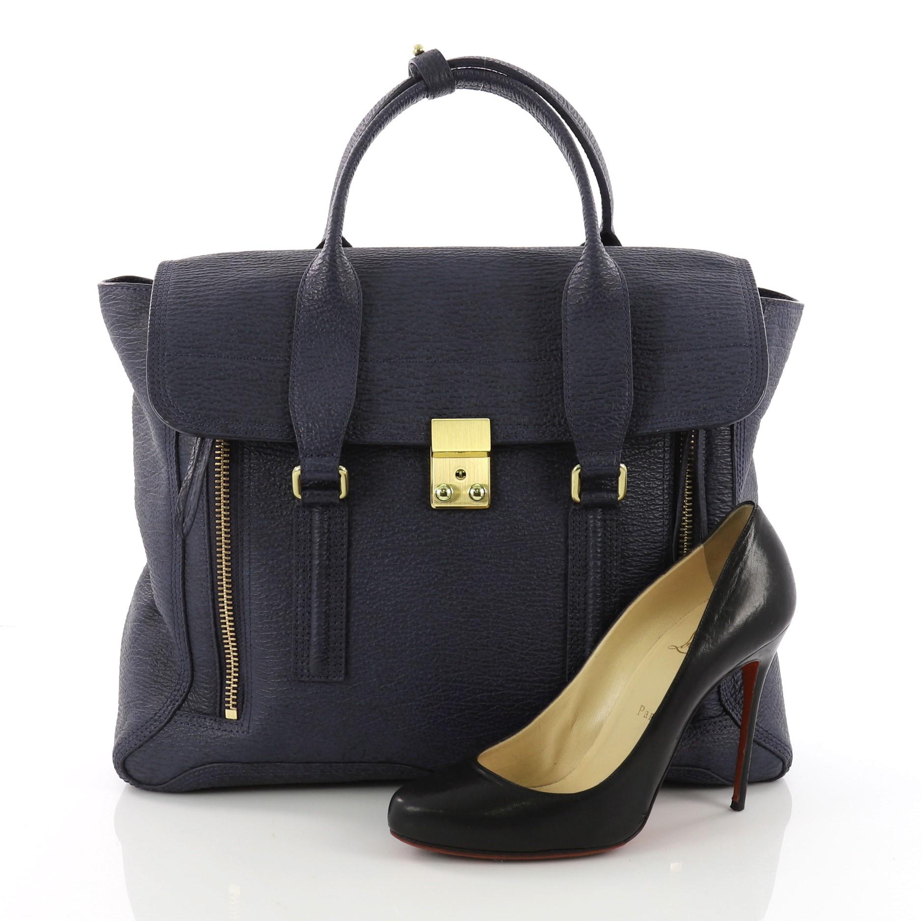 This 3.1 Phillip Lim Pashli Satchel Leather Large, crafted from blue leather, features dual top handles and gold-tone hardware. Its top flap push-lock closure opens to a blue fabric interior with side zip pocket. **Note: Shoe photographed is used as