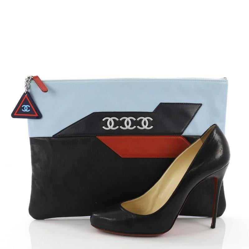 This Chanel Airlines O Case Clutch Leather Large, crafted in black and blue leather, features an airplane motif with CC logo and silver-tone hardware. Its zip closure opens to a blue nylon interior. Hologram sticker reads: 22550361. **Note: Shoe