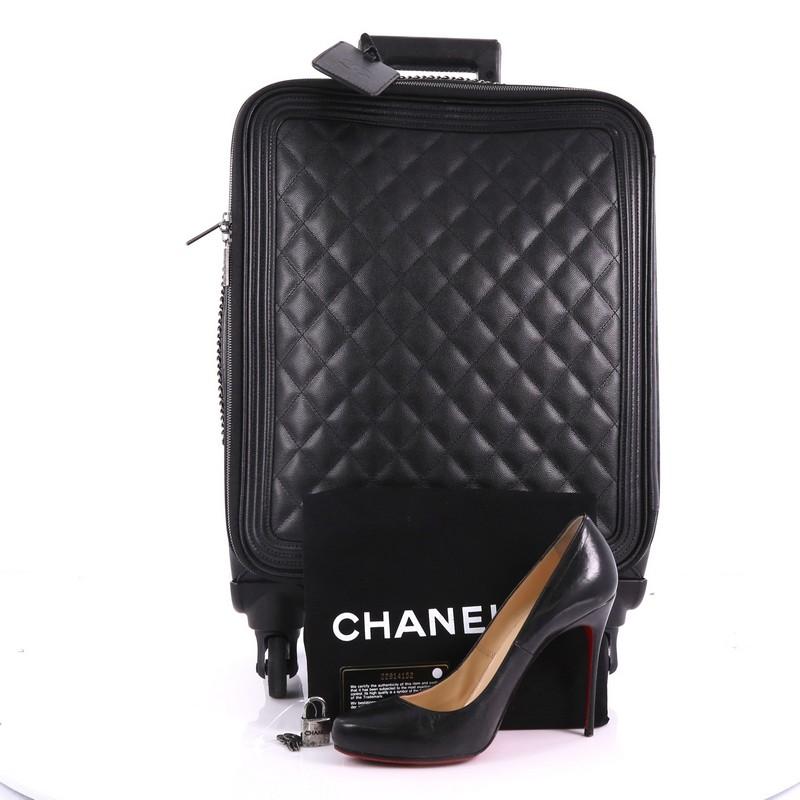 This Chanel Coco Case Rolling Trolley Quilted Caviar, crafted in black quilted caviar, features a telescoping handle, rolling wheels, and aged silver-tone hardware. Its all around zip closure opens to a black fabric interior with zip pockets.