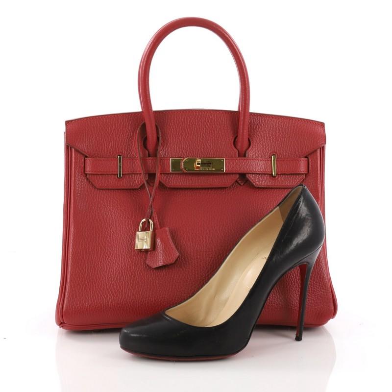 This Hermes Birkin Handbag Rouge Vif Ardennes with Gold Hardware 30, crafted in Rouge Vif ardennes leather, features dual rolled handles, front flap and gold-tone hardware. Its turn-lock closure opens to a red leather interior with slip pocket. Date